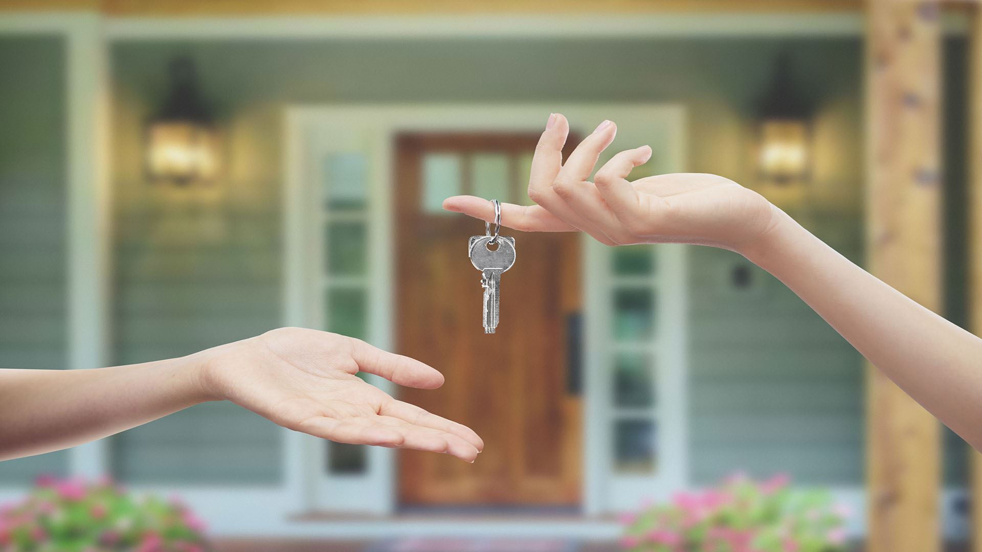 person handing over keys to another